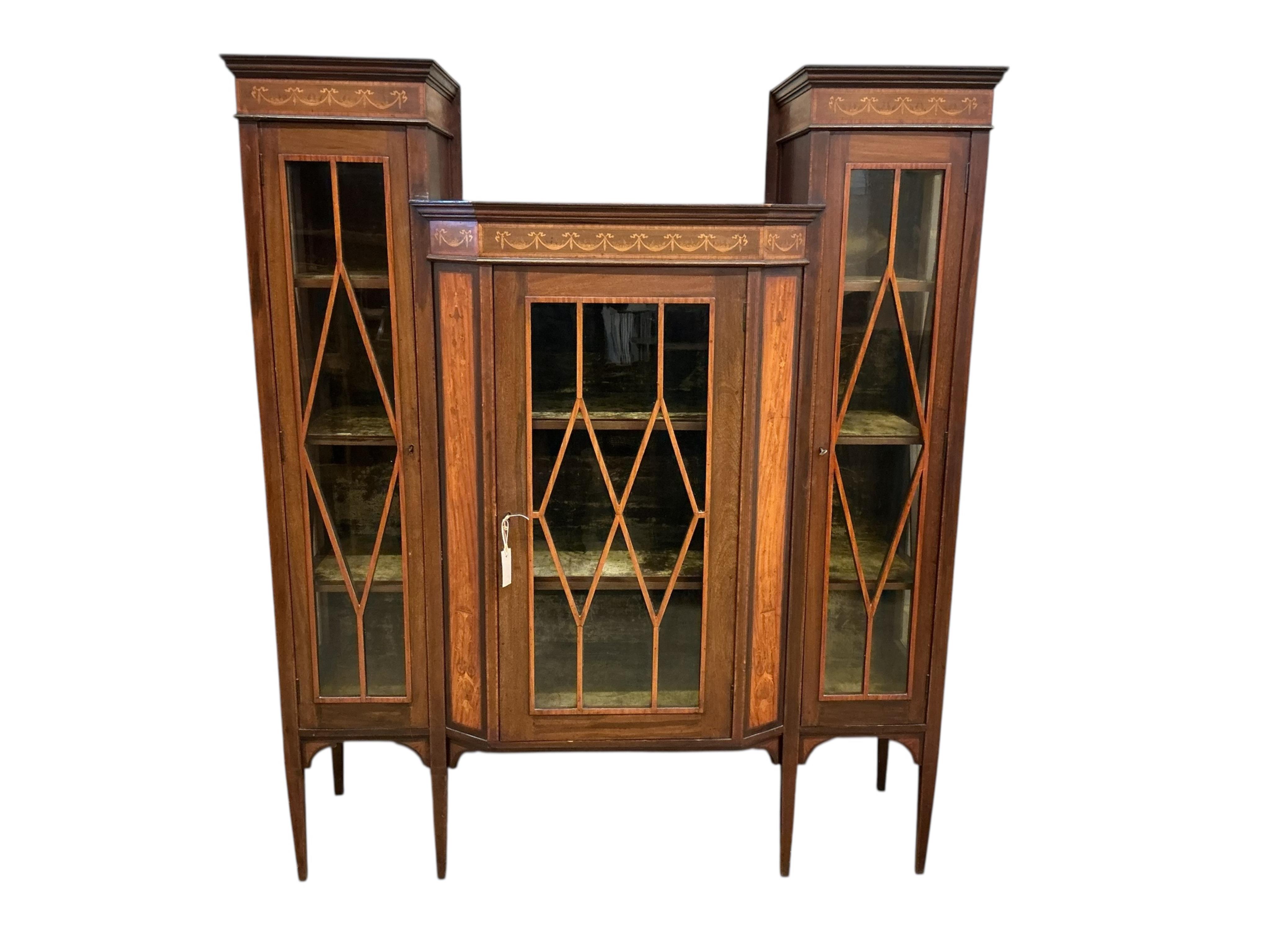 An Edwardian marquetry inlaid mahogany breakfront display cabinet, width 140cm, depth 45cm, height 166cm
